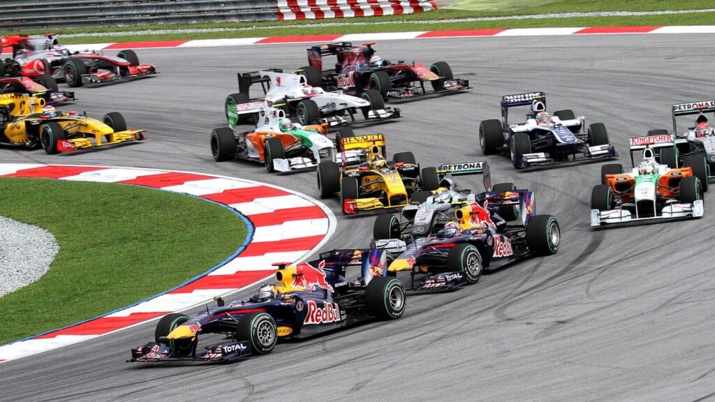 Formula One cars racing through a corner on a Grand Prix circuit
