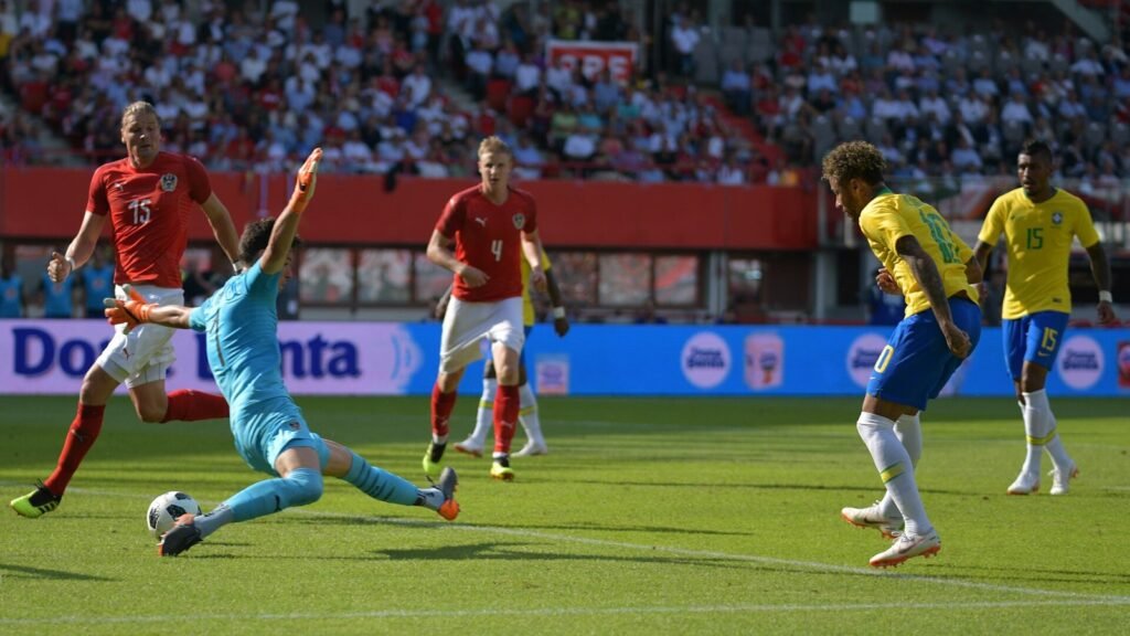 A footballer striking the ball during a competitive match