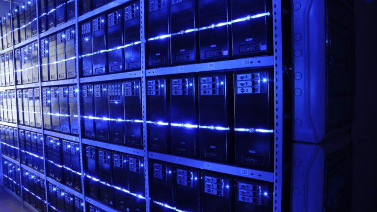 Rows of servers lit in blue inside a modern data centre