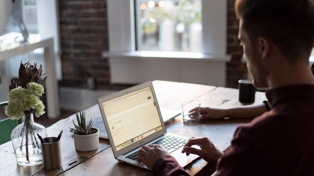 A person working at a laptop computer at a desk