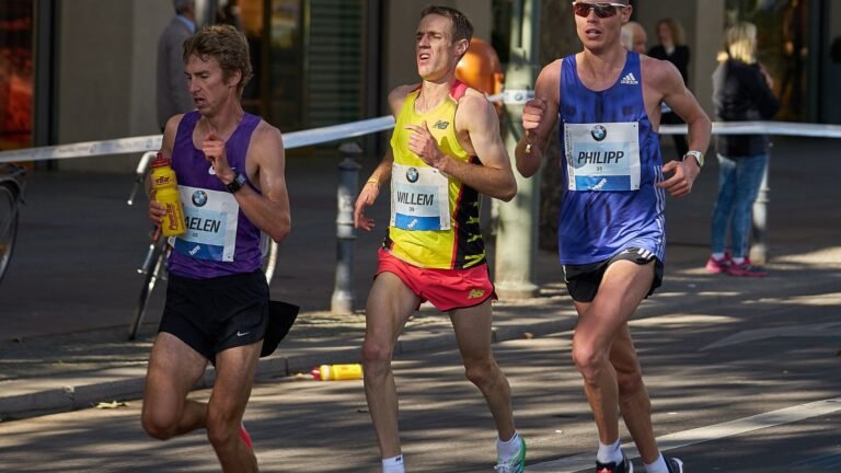 Marathon runners racing along a city street