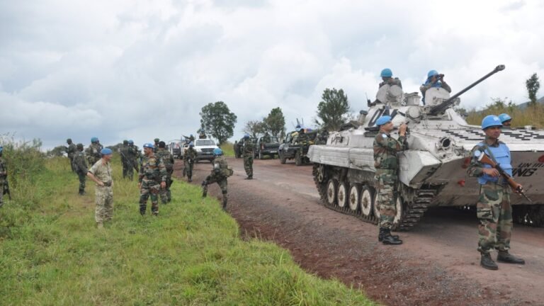 An armoured patrol vehicle on a rural road during a peacekeeping deployment