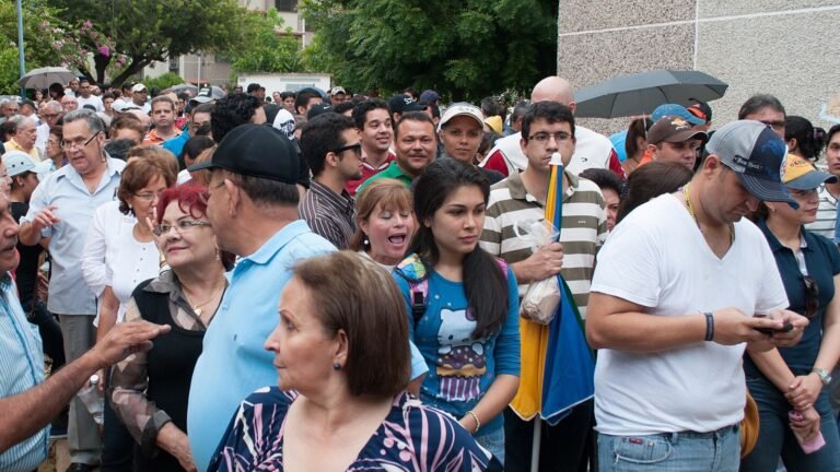 Voters queuing outside a polling station on election day